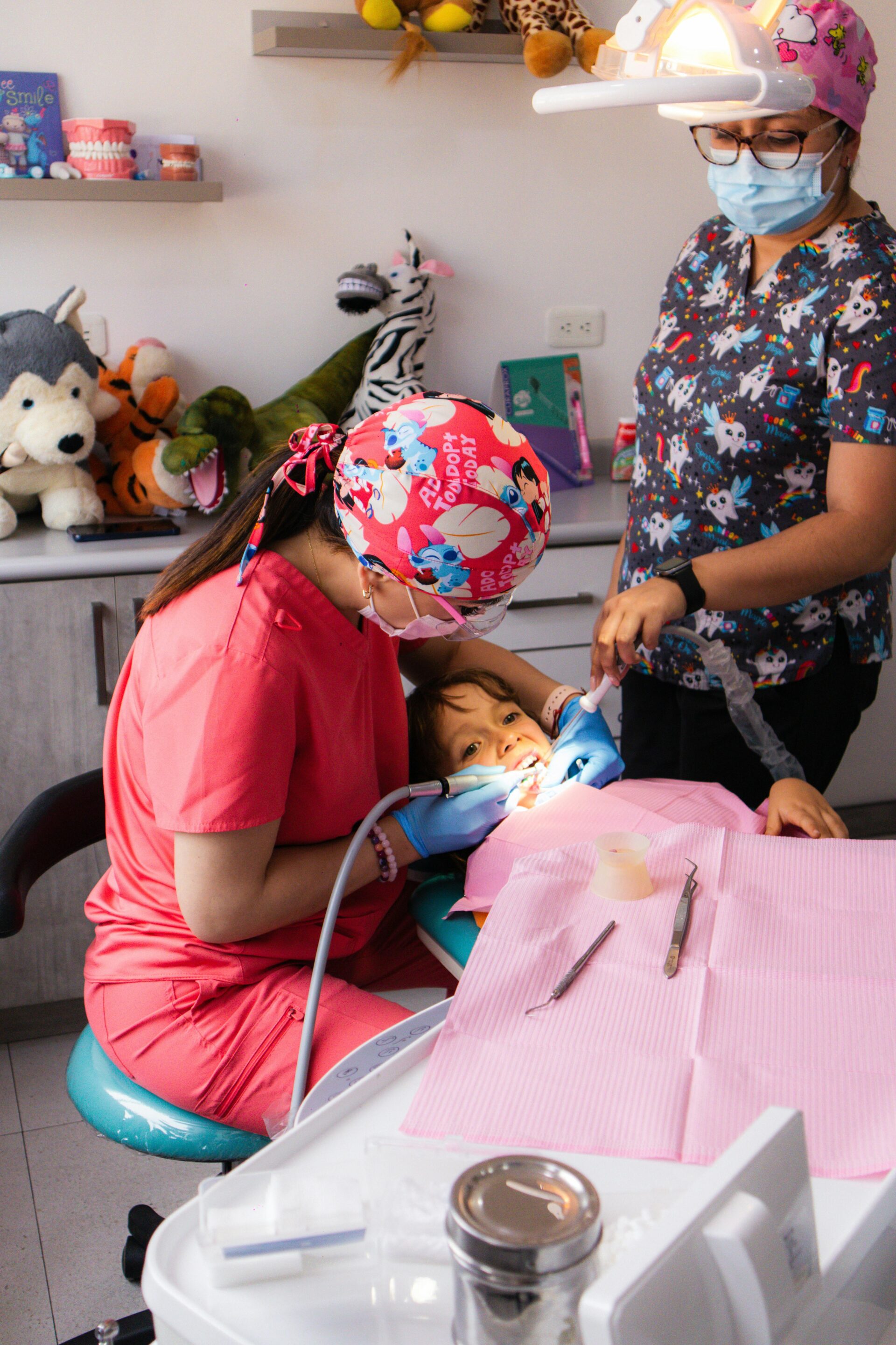 Pediatric dentist treating a child in a colorful clinic