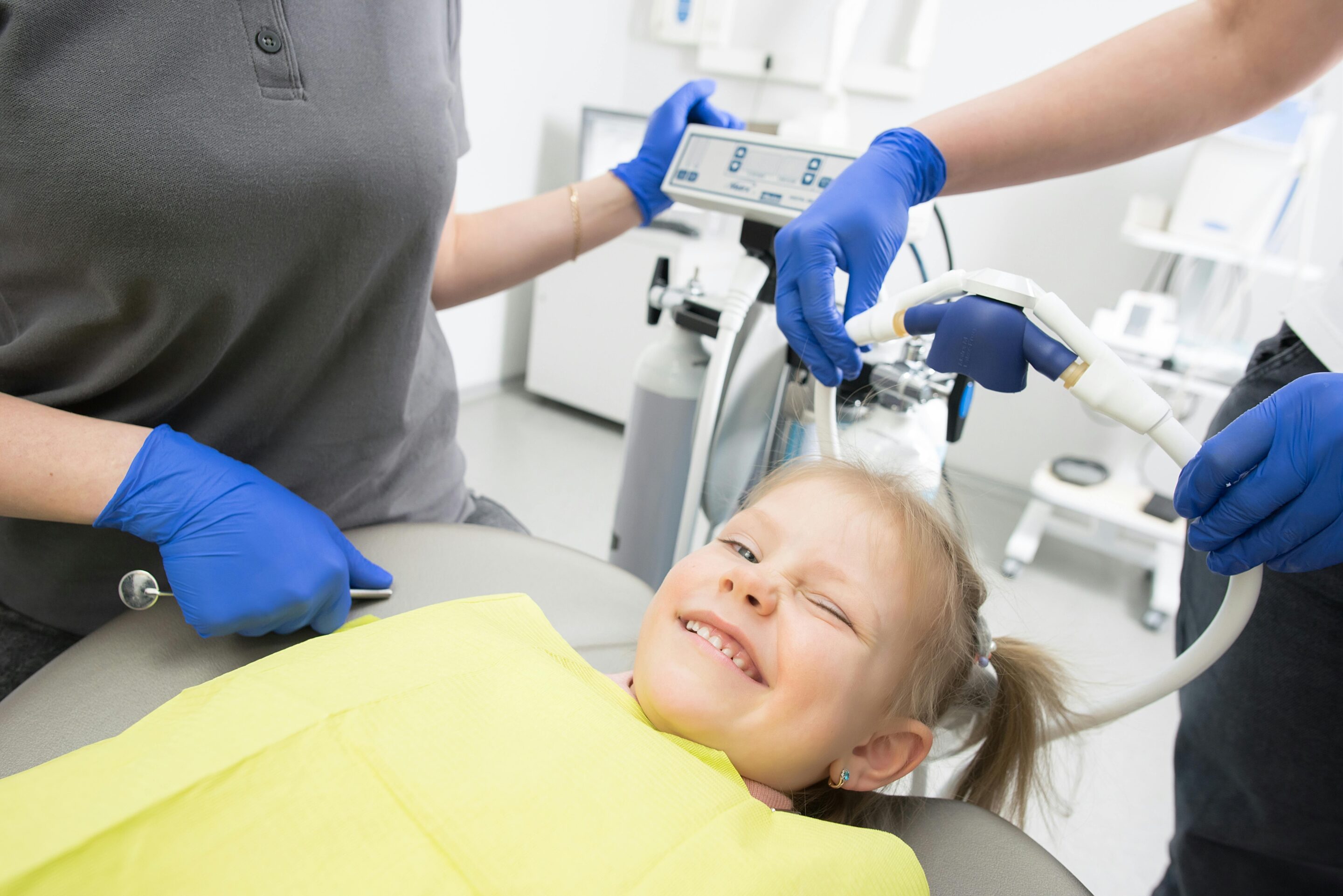 Child smiling in a pediatric dental chair