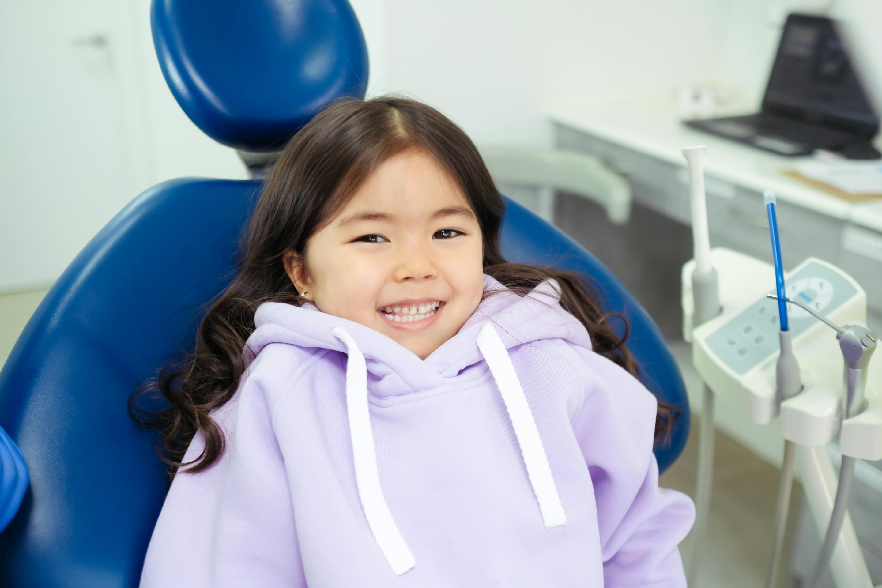 Happy child in a pediatric dental chair