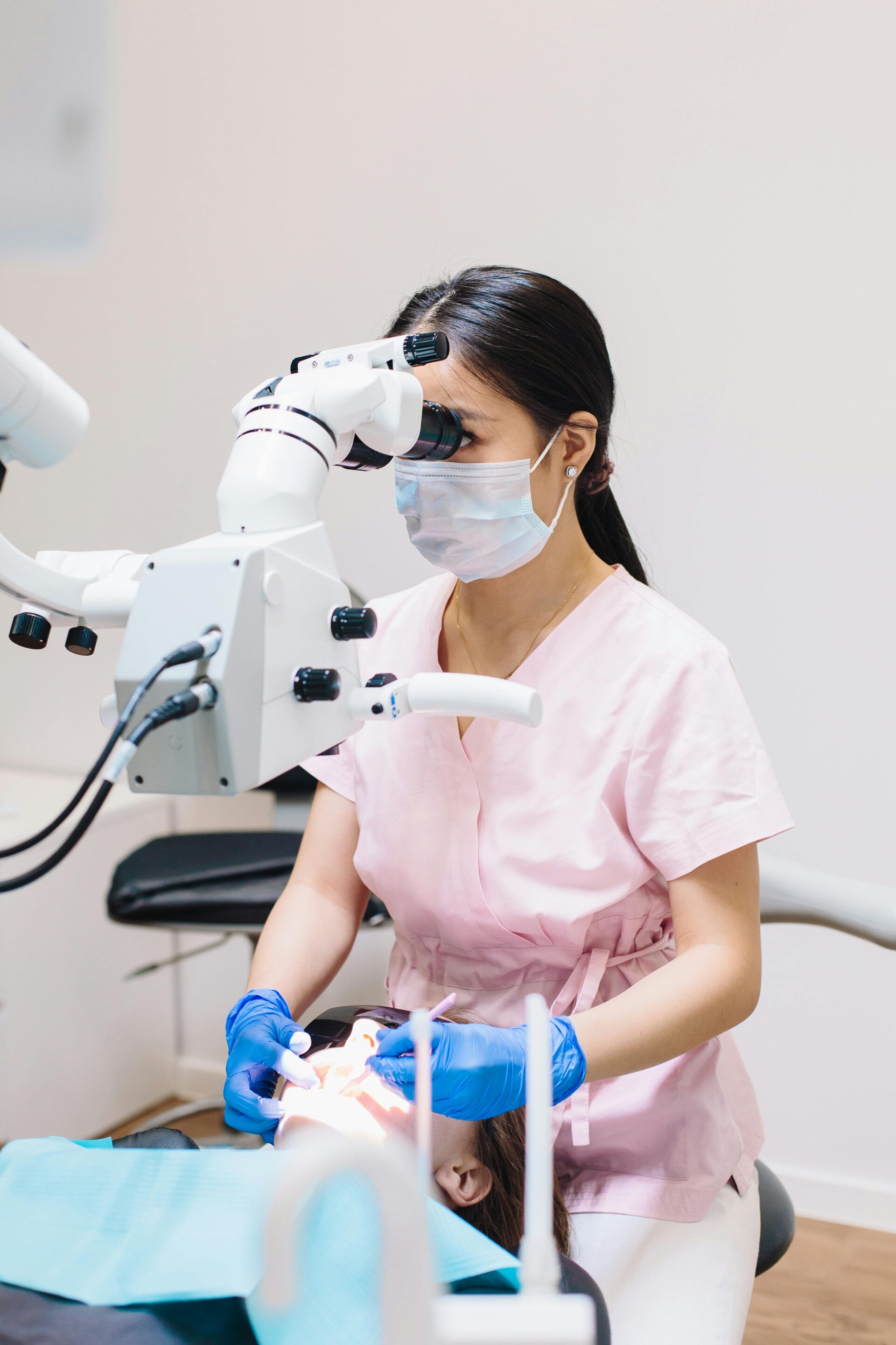 Dental specialist treating a patient with an operating microscope